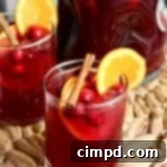 Cranberry Orange Boozy Sweet Tea 3 Cranberry Orange Spiked Sweet Tea in a pitcher with garnishes