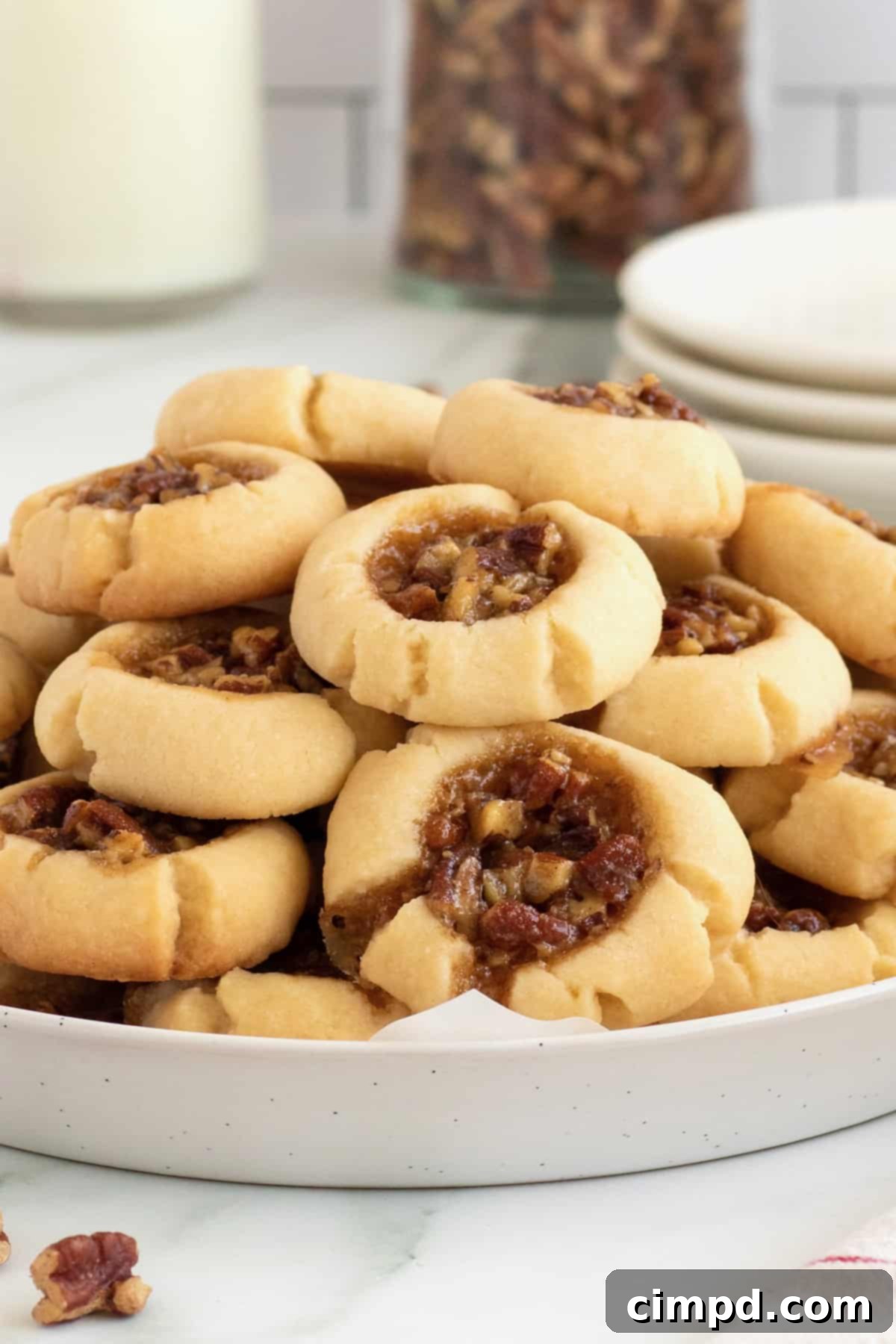 Delicious Pecan Pie Thumbprint Cookies arranged beautifully on a serving plate.