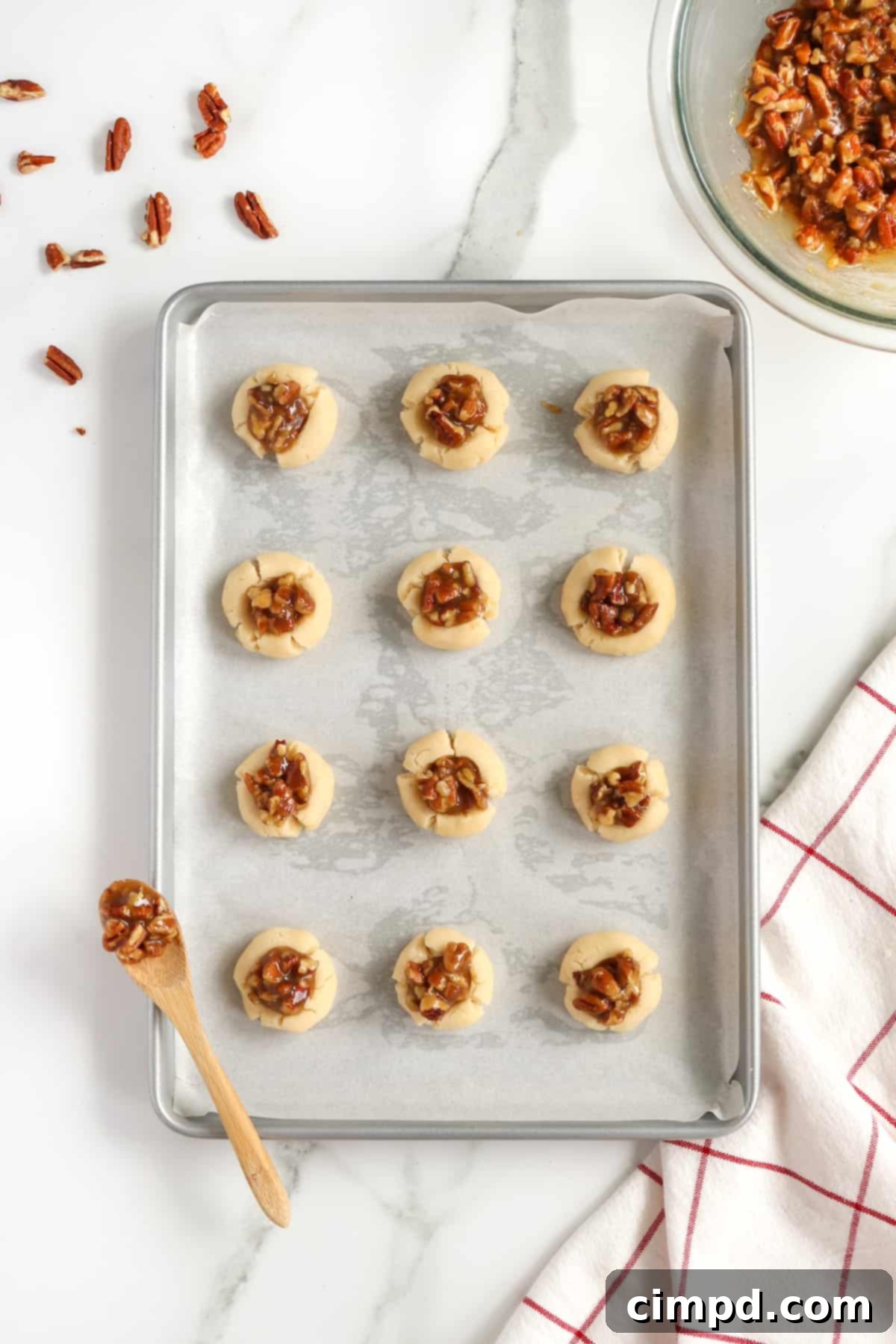 Freshly baked Pecan Pie Thumbprint Cookies cooling on a wire rack.