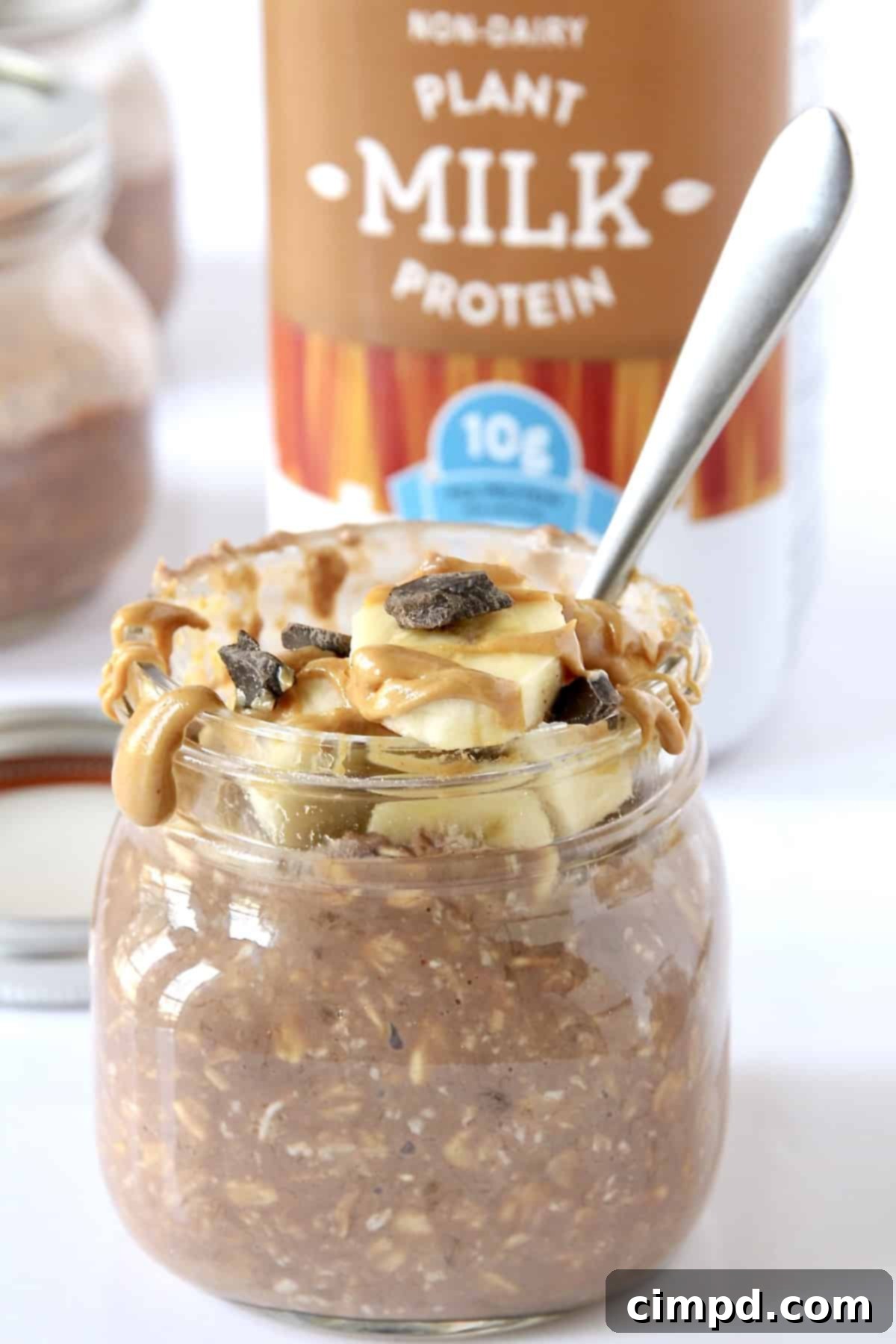 Power-Packed Chocolate Peanut Butter Banana Overnight Oats 5 Jar with Chocolate Peanut Butter Banana Protein Overnight Oats ingredients being stirred