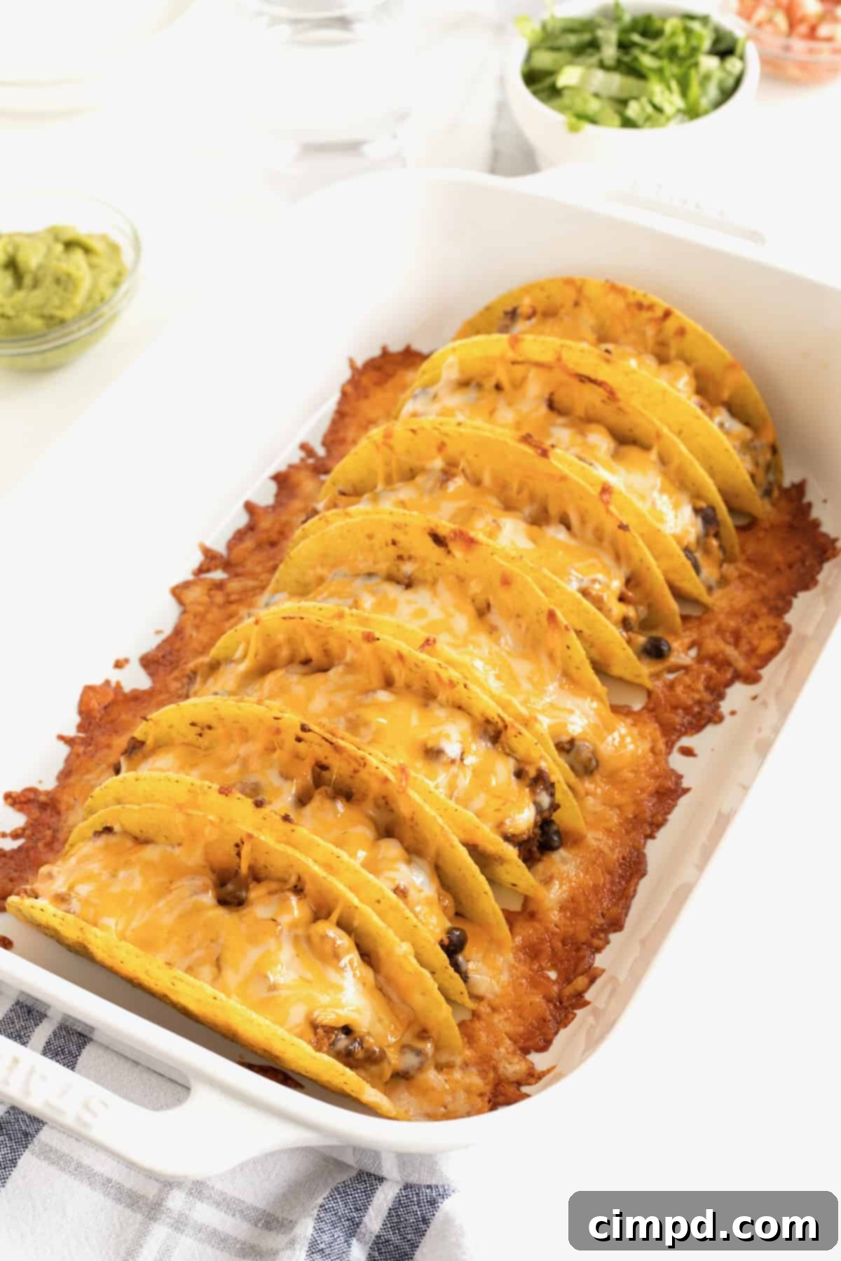 Meals of Kindness 5 Seven delicious turkey and black bean baked tacos with melted cheese in a baking dish.