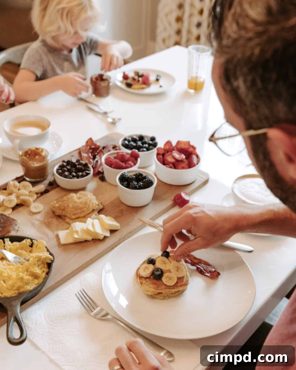 Happy family enjoying their Sunday breakfast together at the dining table