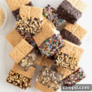 A pile of graham cracker ice cream sandwiches that have been dipped halfway in chocolate.