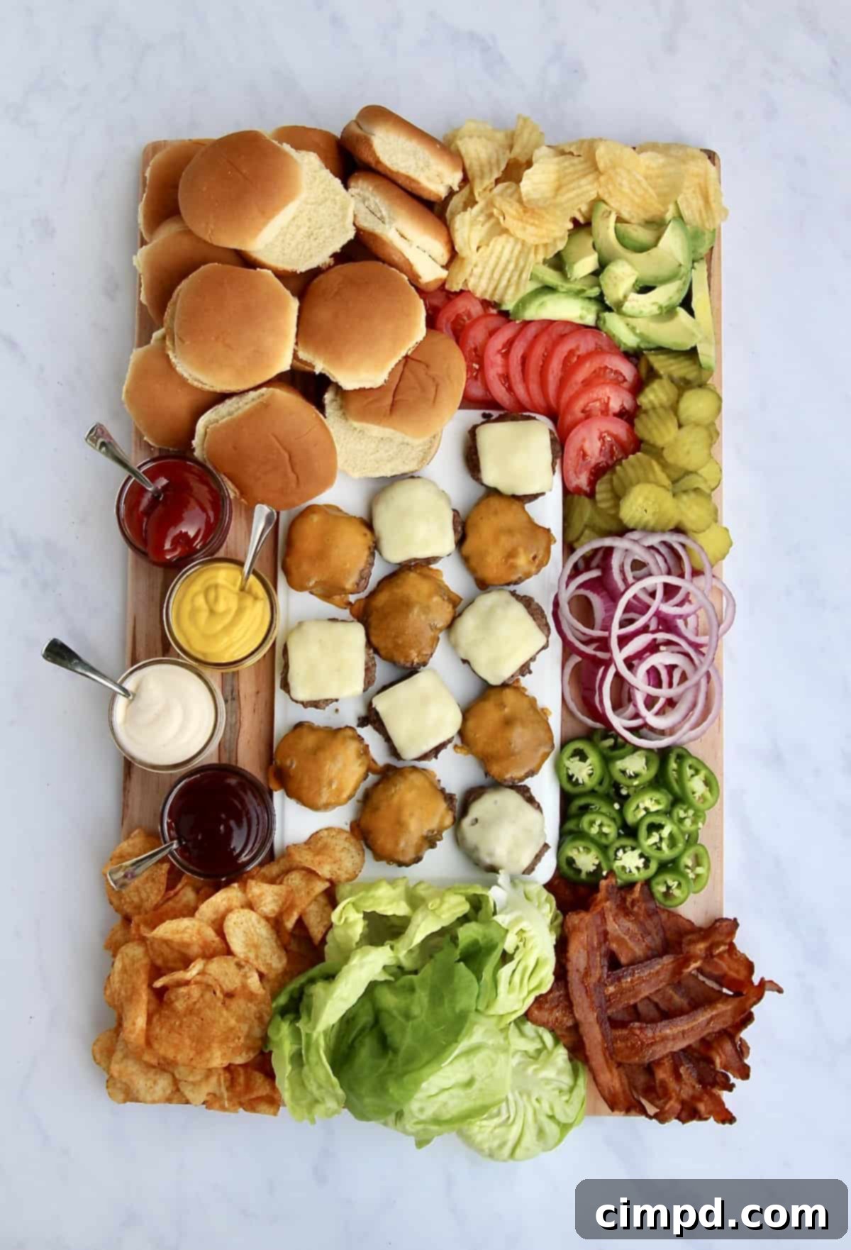 A vibrant Build-Your-Own Burger Board overflowing with various toppings, cheeses, buns, and sauces, ready for guests to assemble their custom burgers.