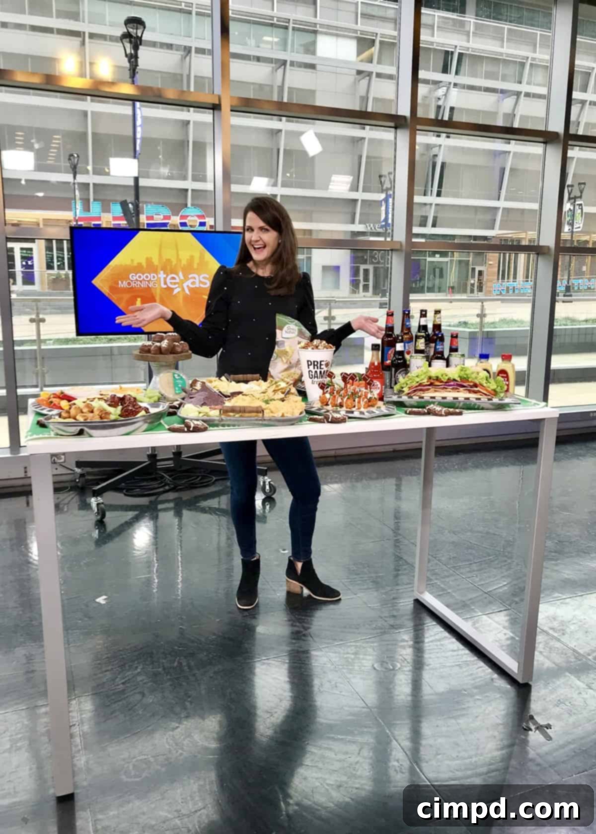 The Ultimate Super Bowl Spread with The BakerMama - TV segment screenshot showing a bountiful game day food display.