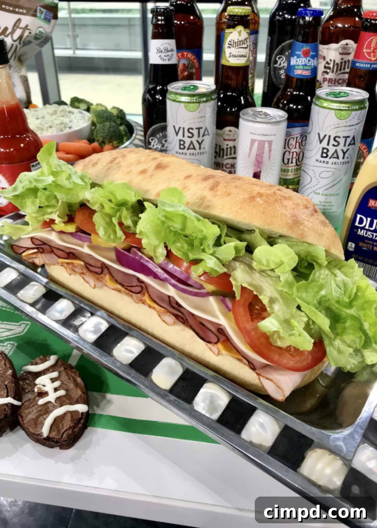 The Ultimate Super Bowl Spread - A massive, loaded sub sandwich pre-sliced for easy serving.