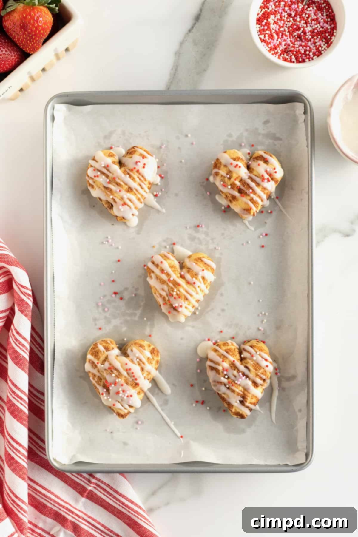 Sweetheart Swirls 7 Beautifully decorated heart-shaped cinnamon rolls with sprinkles