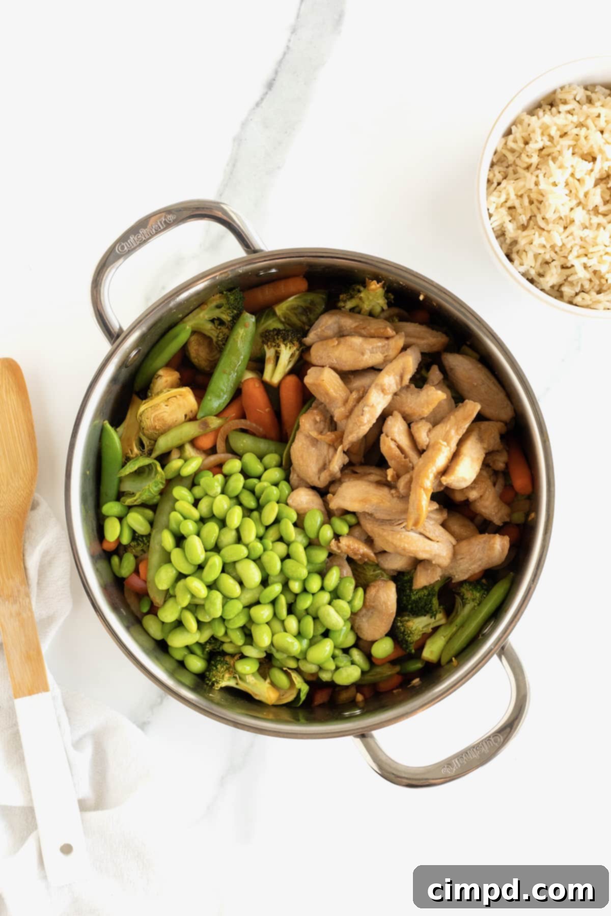 A bountiful stir fry featuring glistening chicken and an array of colorful vegetables, perfectly cooked and tossed in the signature sweet and spicy sauce, ready to be served.