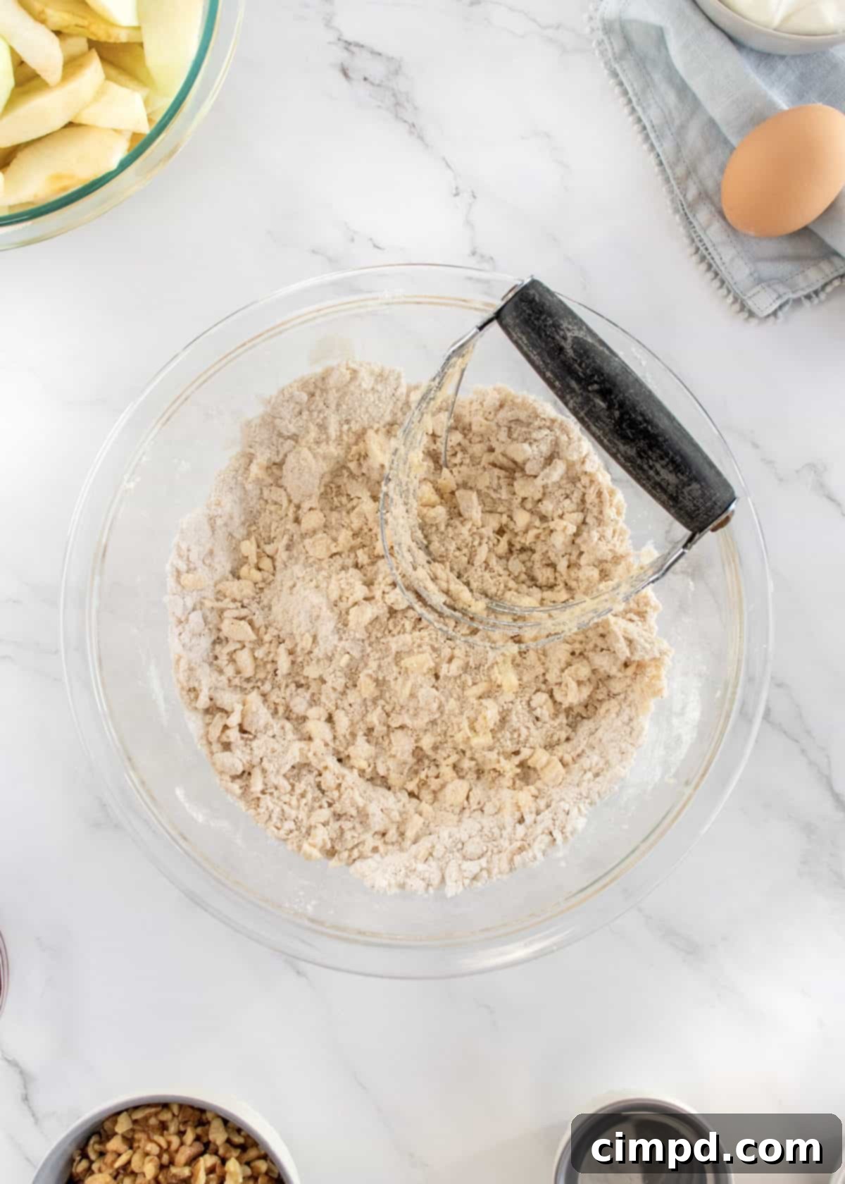 Mom's Signature Apple Pie 4 Hands preparing the pie crust dough on a lightly floured surface.