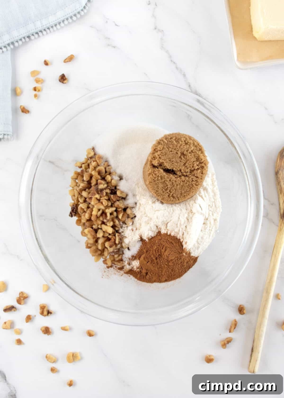 Mom's Signature Apple Pie 8 The streusel topping being sprinkled evenly over the partially baked apple pie.