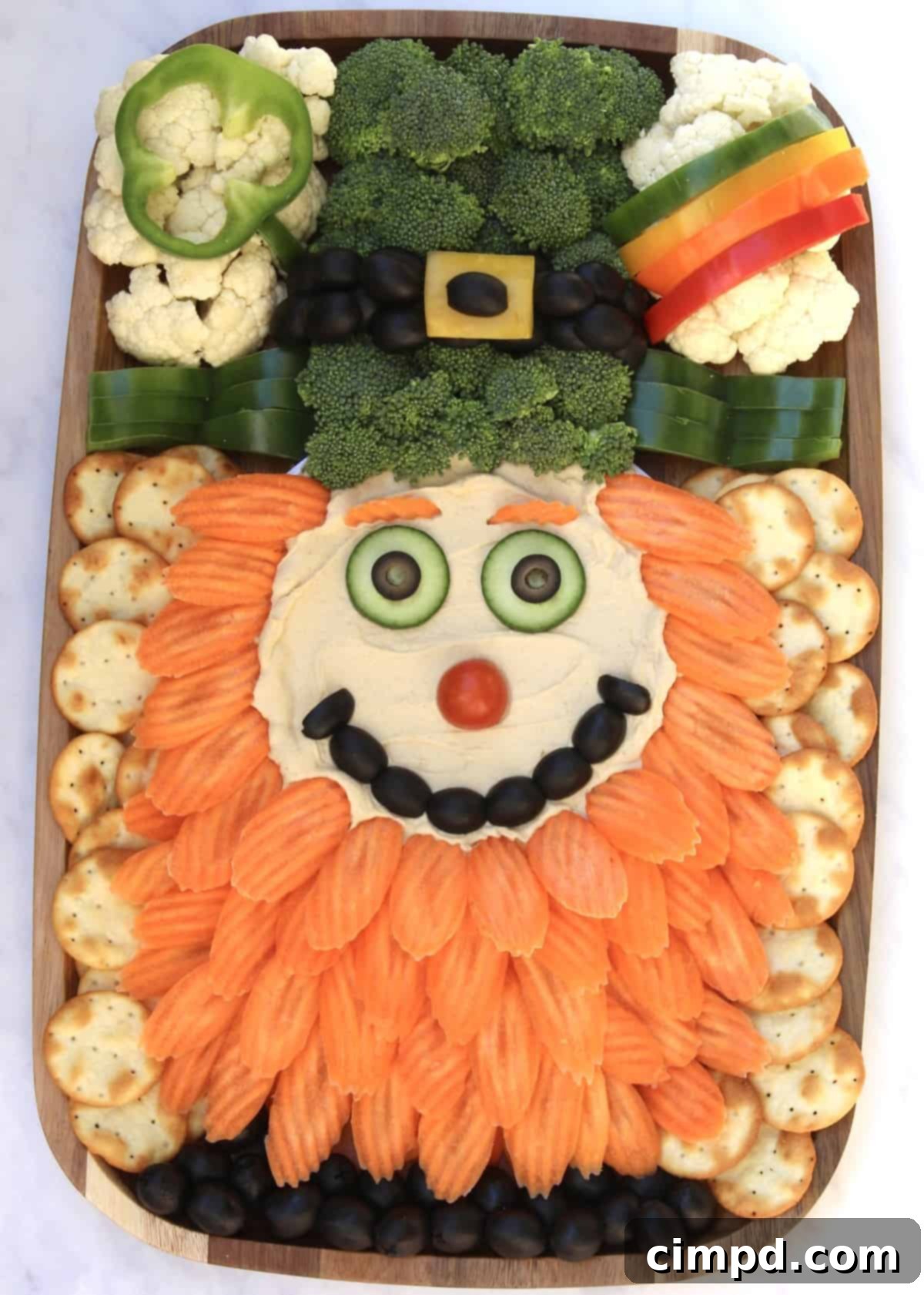 Close-up of the adorable Leprechaun Snack Board with hummus and fresh veggies