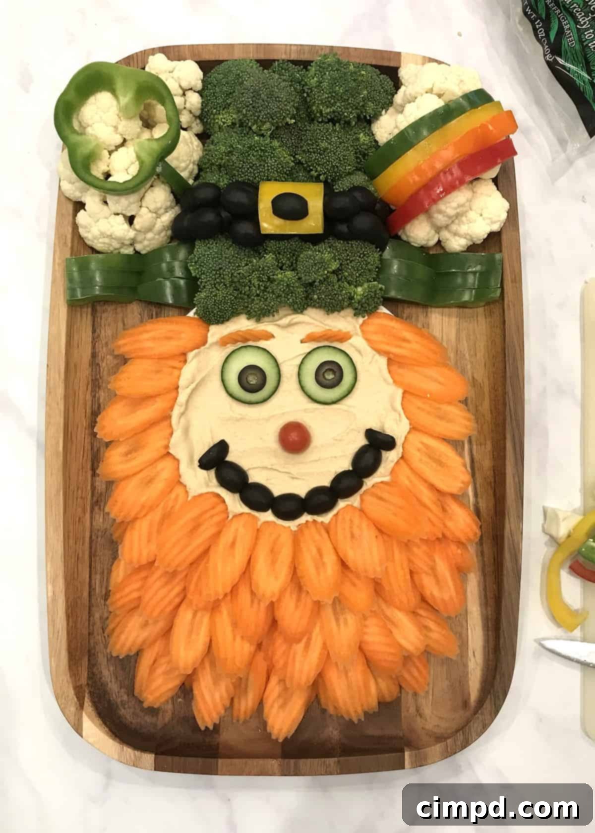 Cauliflower clouds with shamrock and bell pepper rainbow on Leprechaun Snack Board