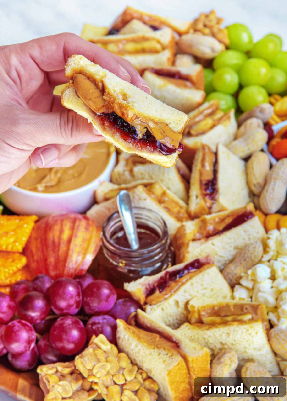 An overhead shot showcasing the full spread of a PB&J Snack Board, rich with color and variety.