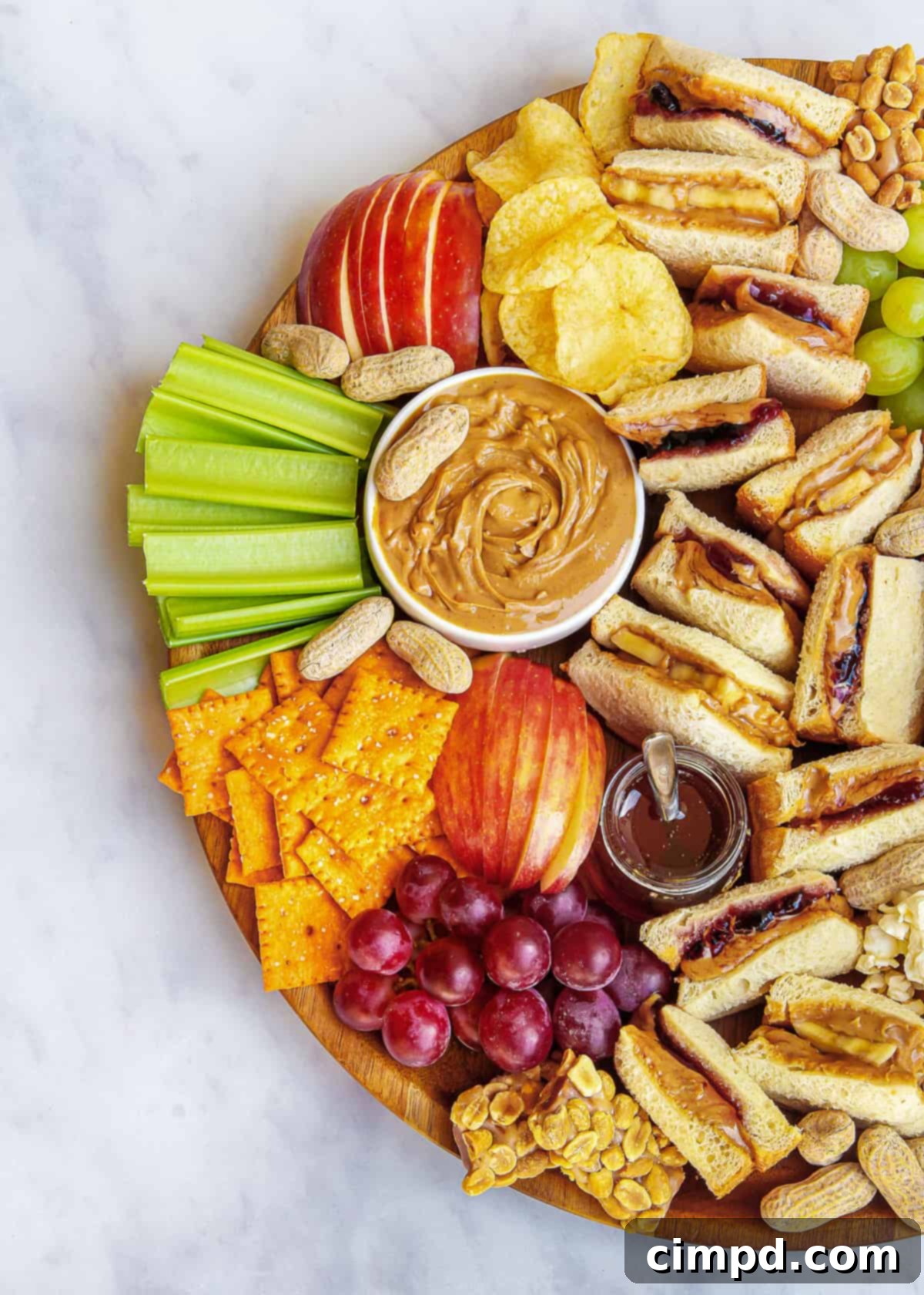 Detailed view of the healthy side of the PB&J Snack Board with fruits, celery, and peanut butter.