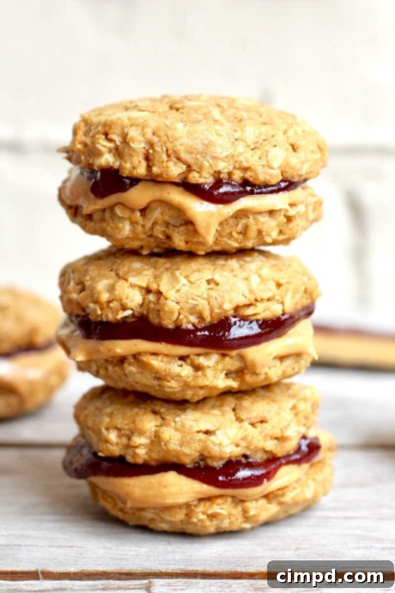 Healthy Flourless Peanut Butter & Jelly Cookie Sandwiches on a white plate