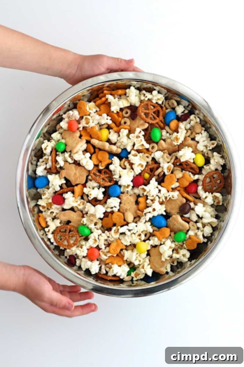 Pantry Popcorn Mix in a large white bowl with various toppings