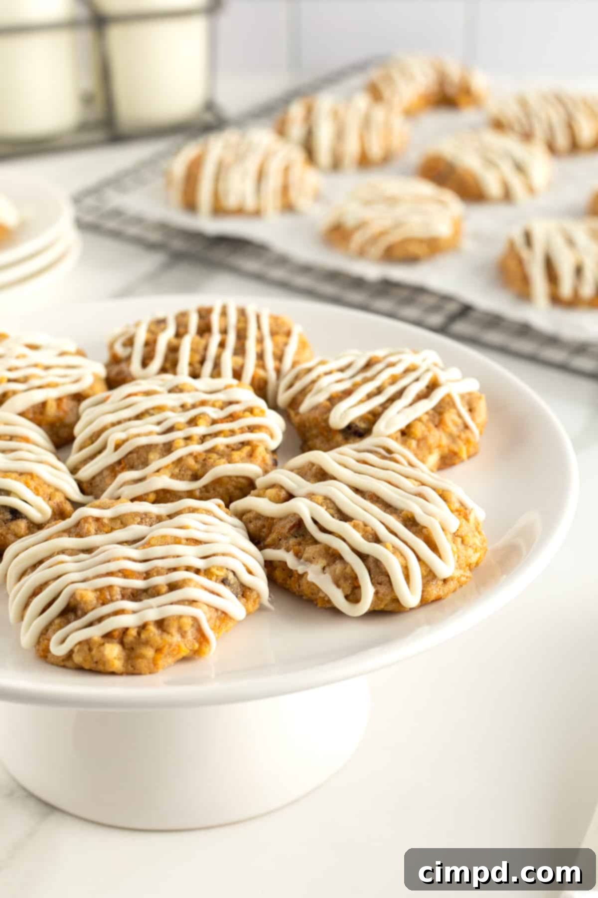 Carrot Cake Cookies by The BakerMama, topped with white chocolate drizzle, perfect for spring