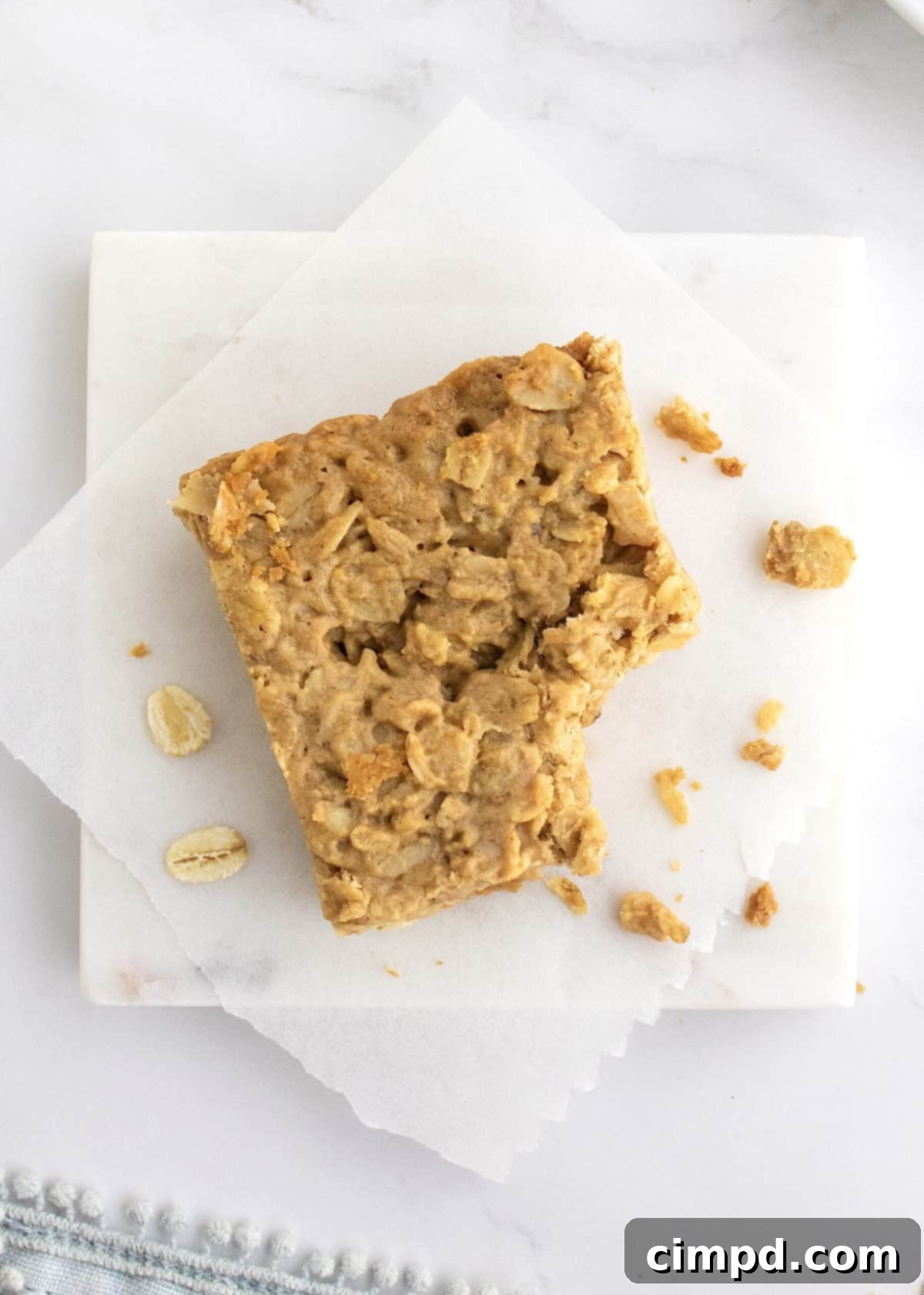 Close-up of a single peanut butter honey oat bar, highlighting its chewy texture and golden color.