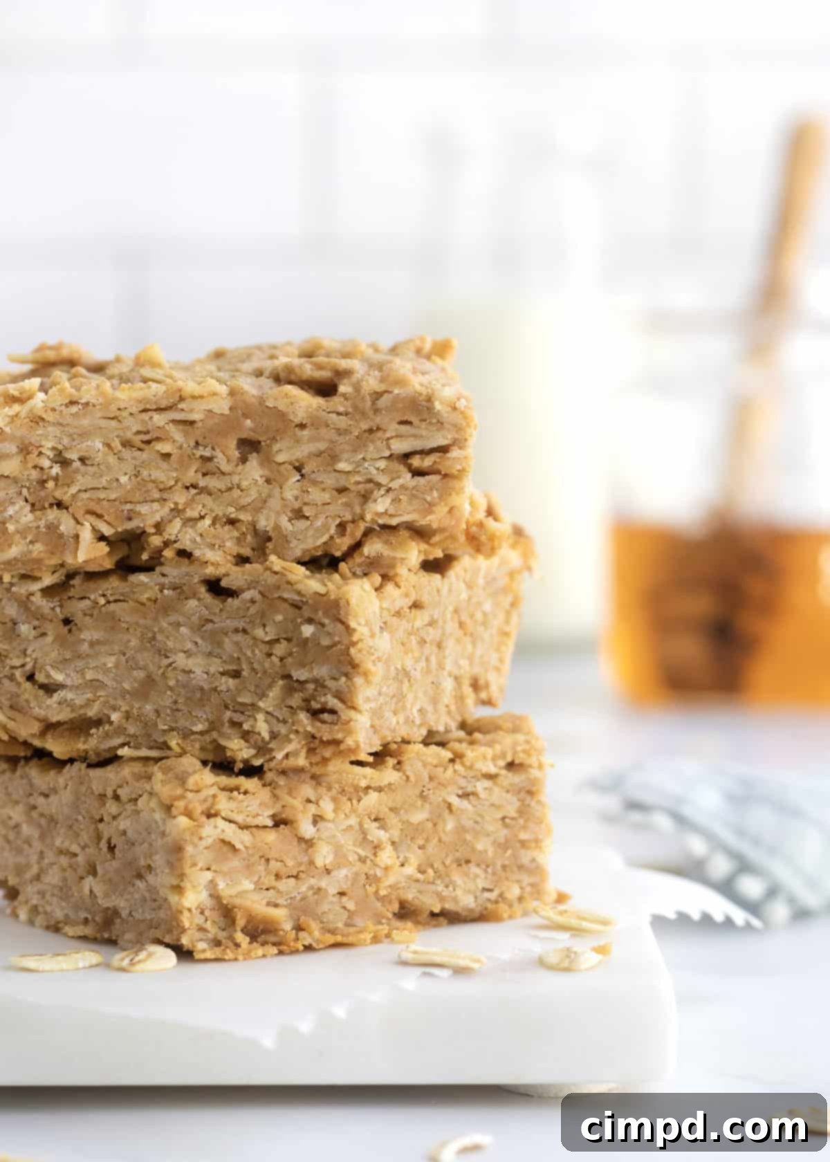 A stack of perfectly cut 3-Ingredient Peanut Butter Honey Oat Bars, ready for storage or immediate enjoyment.