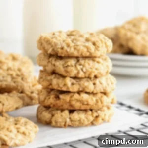 Spiced October Treats 11 A stack of 5 October Cookies on a parchment lined metal cooling rack, with more cookies piled on plates in the background.