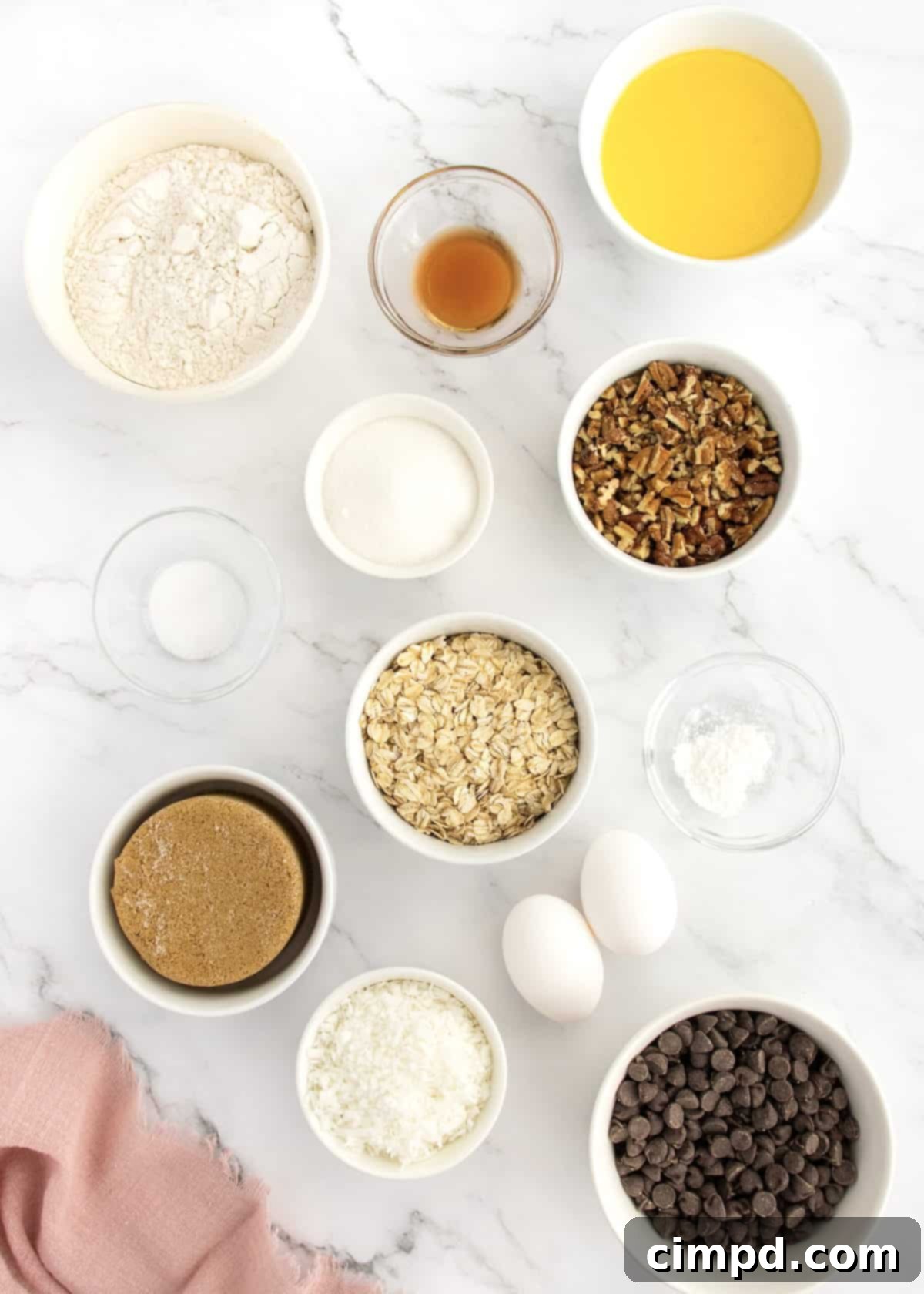 A stack of golden brown Coconut Pecan Chocolate Chip Oatmeal Cookies on a cooling rack