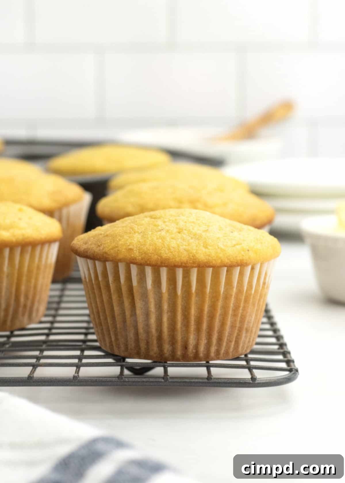 Freshly baked Honey Corn Muffins cooling on a wire rack