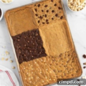 6-in-1 Sheet Pan Cookie Bar assortment on a white plate with one bar taken a bite from