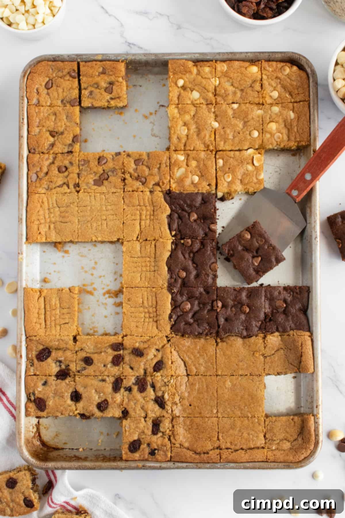 Close-up of the finished 6-in-1 Sheet Pan Cookie Bars, showing the distinct textures and toppings of each flavor after baking and cooling.