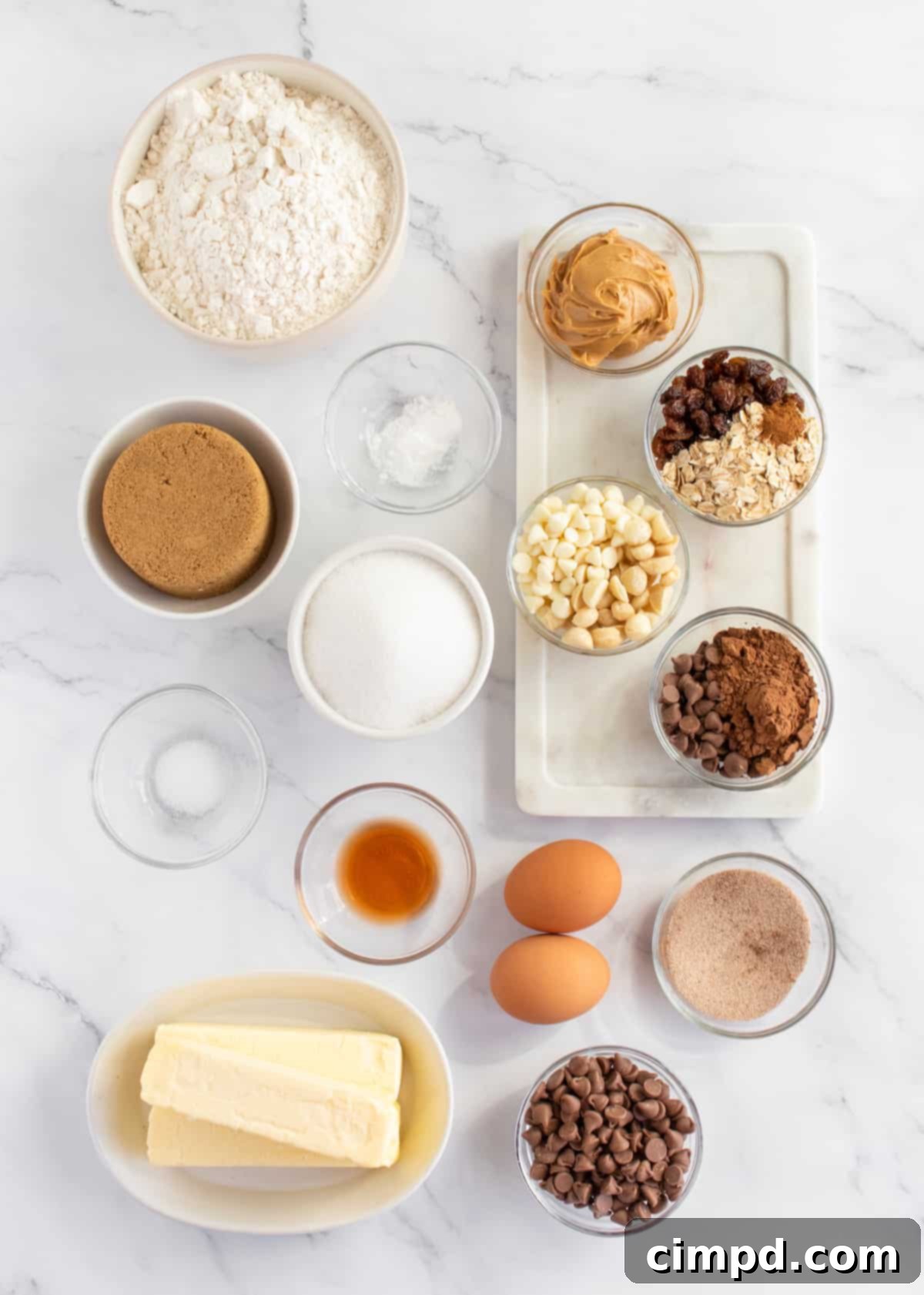 All the ingredients for the cookie bars laid out on a kitchen counter, showcasing the variety of mix-ins and baking essentials.