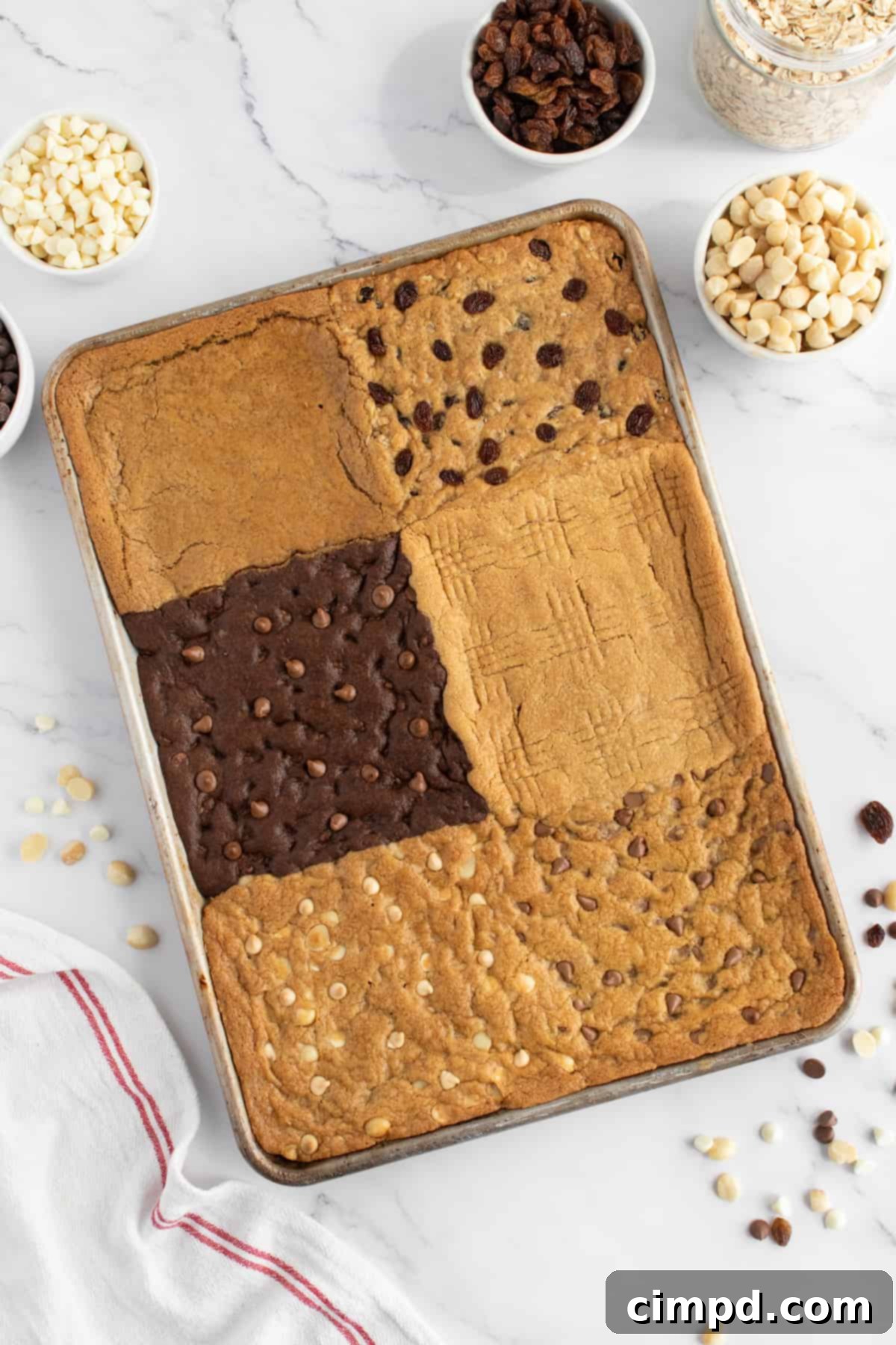 The fully baked and cooled 6-in-1 Sheet Pan Cookie Bars, partially sliced, revealing the distinct layers and textures of each flavor.