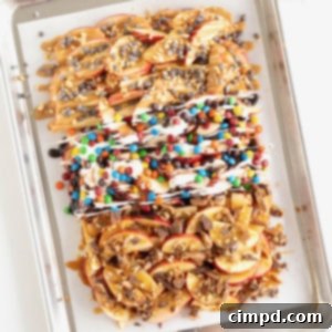 Loaded Apple Slices 12 A parchment lined aluminum baking sheet covered with apple nachos.