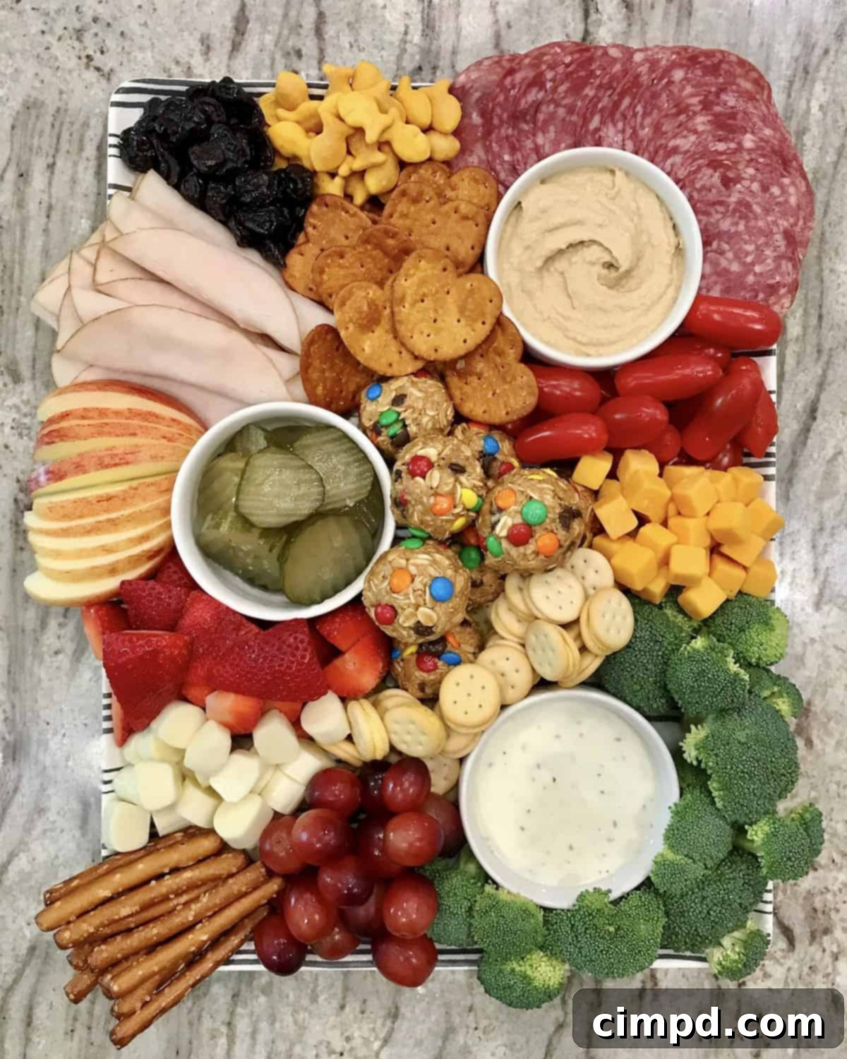 Snack Board featuring an assortment of treats and savory items, including No-Bake Monster Balls.