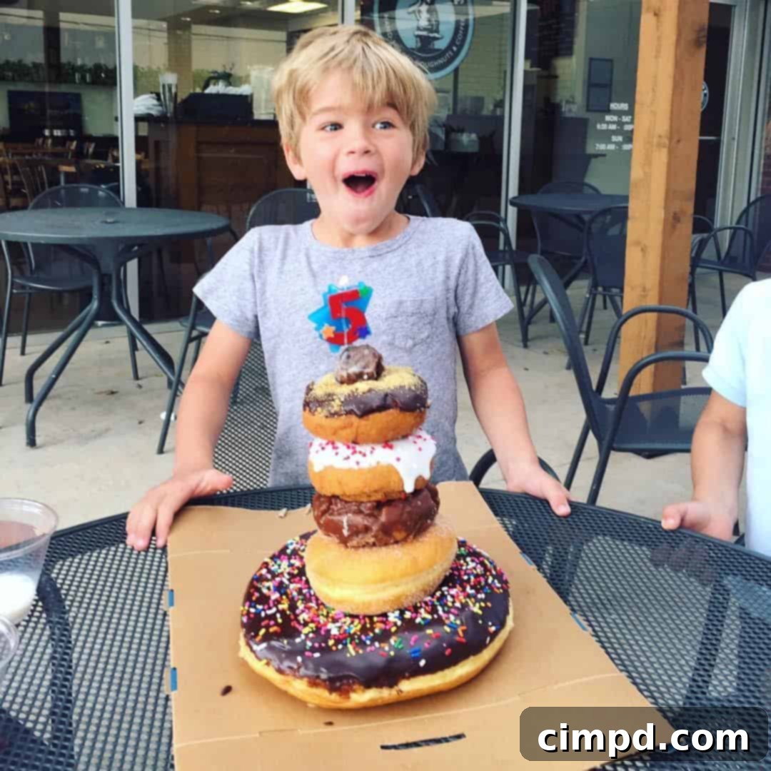 A festive birthday donut cake adorned with candles, ready for a celebration, highlighting its unique charm.
