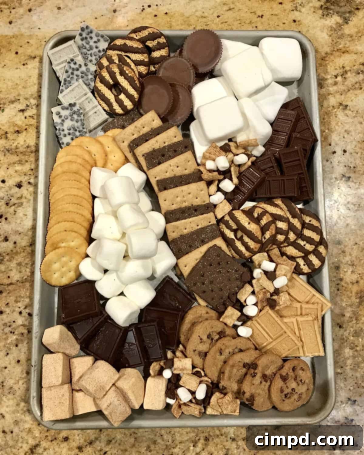 A S'mores Tray laden with a variety of sweet treats, including different chocolates, marshmallows, and cookies, beautifully arranged for a dessert bar.