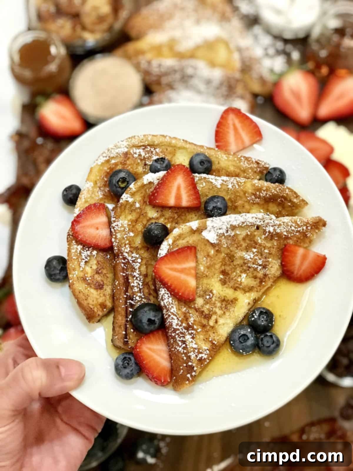 The Ultimate French Toast Brunch Board 3 Close-up of golden French Toast slices with powdered sugar and fresh berries