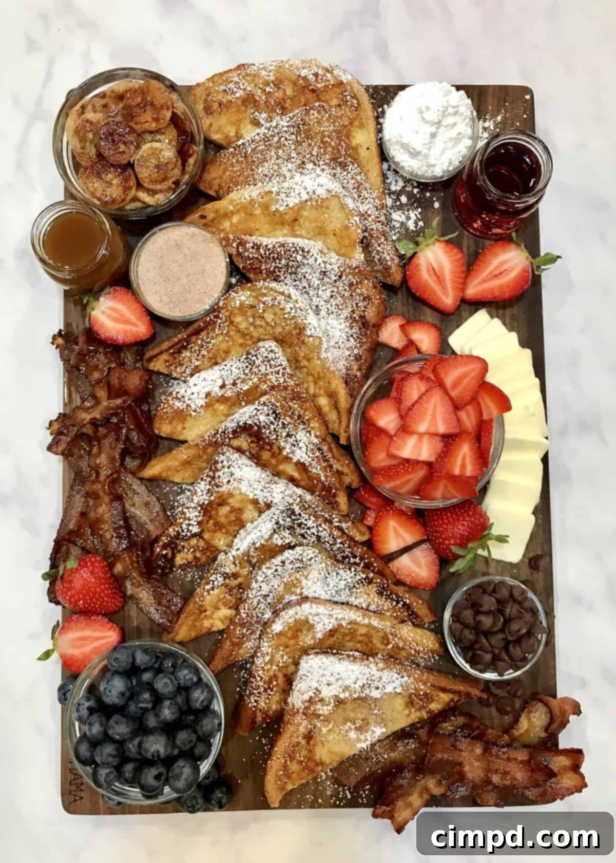 The Ultimate French Toast Brunch Board 5 An elaborate display of French Toast toppings including fruits, sauces, and nuts