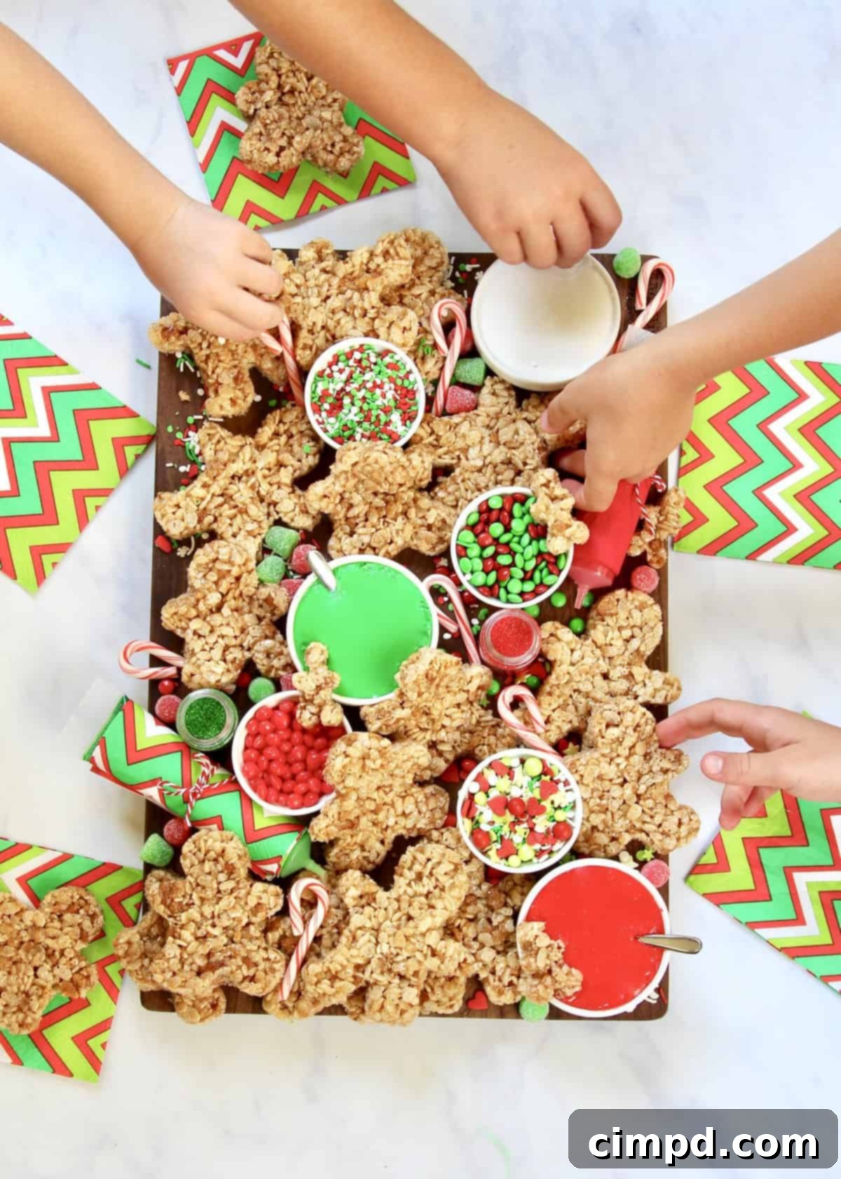Overhead view of a beautifully arranged no-bake gingerbread men decorating board.