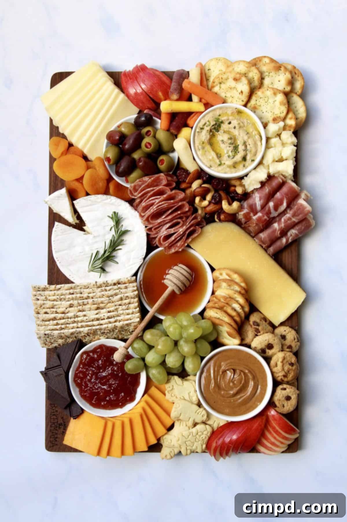 The Ultimate Holiday Grazing Board, beautifully arranged with a variety of cheeses, meats, fruits, and crackers, showcasing a vibrant and appealing spread for holiday entertaining.