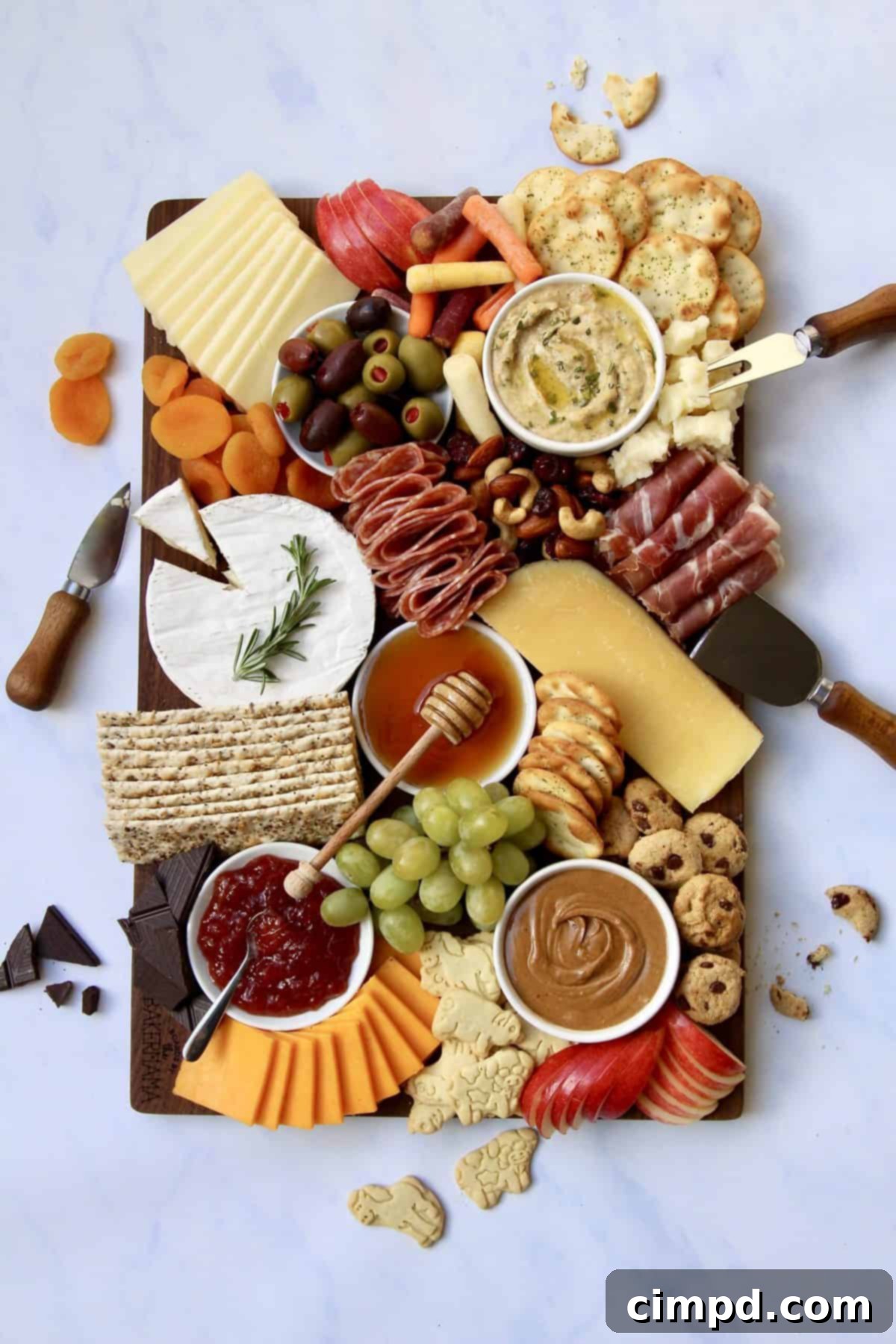 A vibrant and inviting holiday grazing board featuring an array of assorted cheeses, fresh fruits, crispy crackers, and delectable spreads, all ready to be enjoyed.