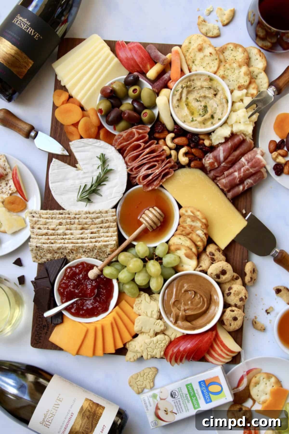 A beautifully composed section of the ultimate holiday grazing board, highlighting artfully arranged cheeses, various crackers, and complementary garnishes.