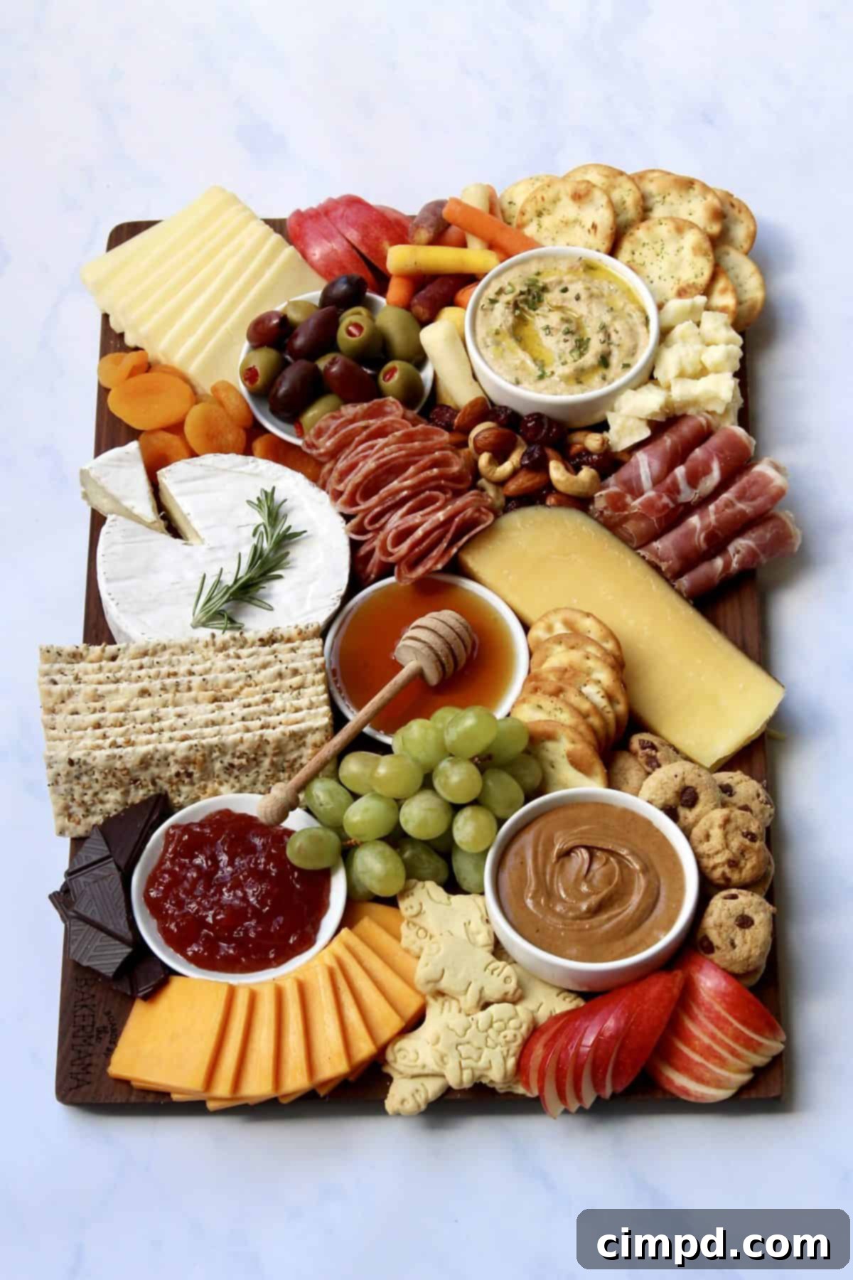 The Ultimate Holiday Grazing Board showcasing a balanced arrangement of cheeses, meats, crackers, and fruits, demonstrating a rich and inviting spread.
