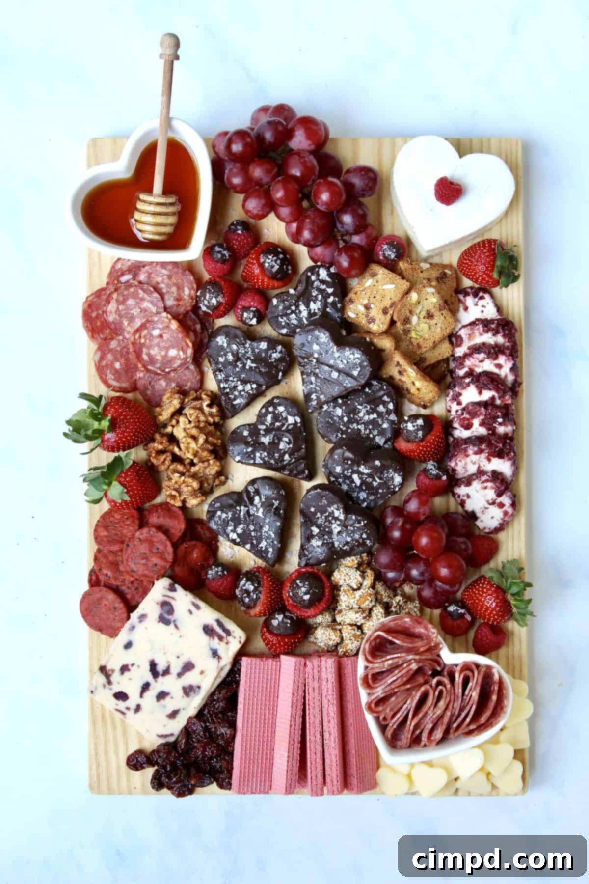 Close-up of a vibrant Galentine's Fudge and Cheese Board, highlighting heart-shaped fudge, artisan cheeses, and colorful fruits.