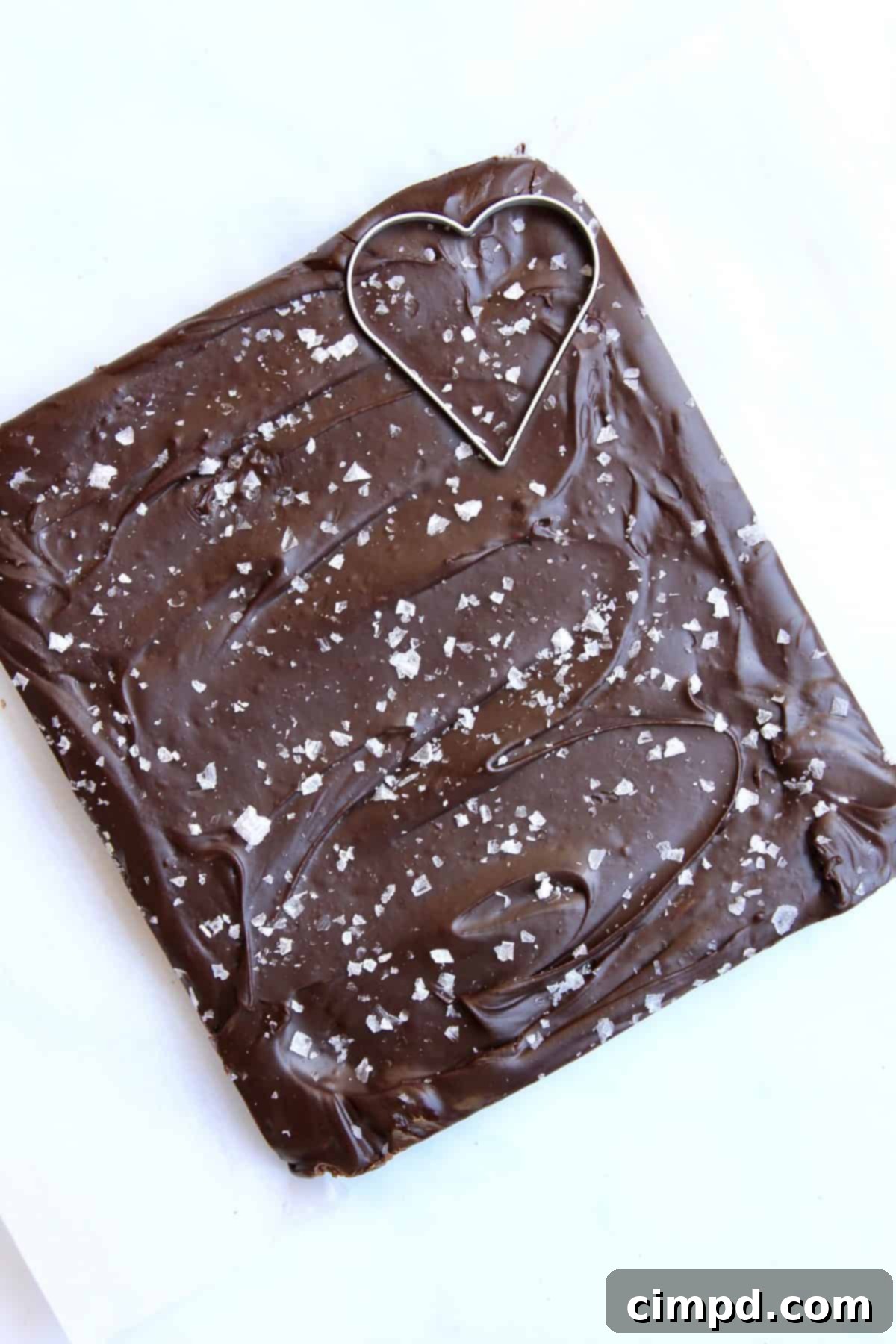 Heart-shaped pieces of Karo Dark Chocolate Fudge with Sea Salt, ready for a Galentine's Day board.