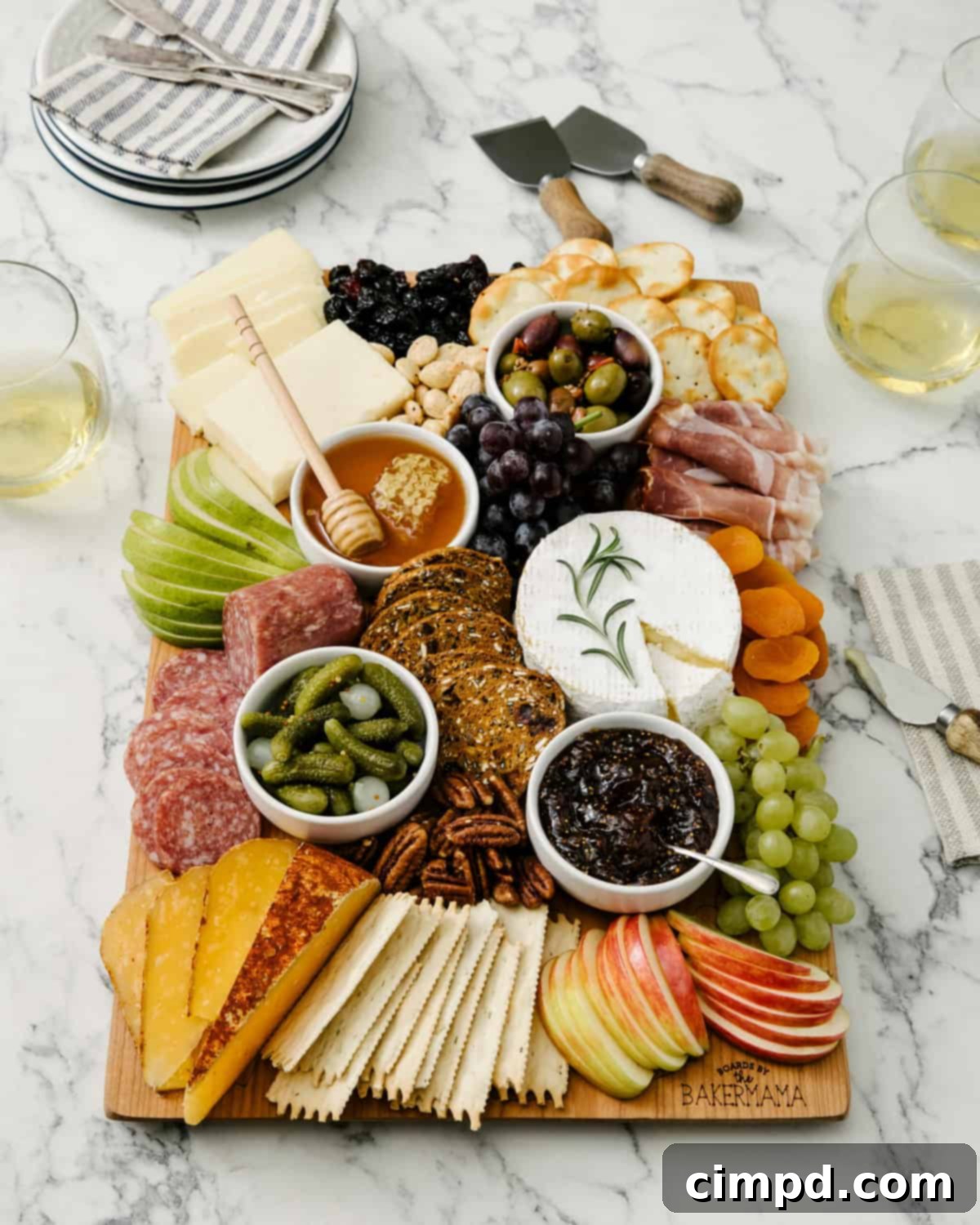 A close-up of The BakerMama's Signature Board, showcasing the detailed engraving and a vibrant array of food.