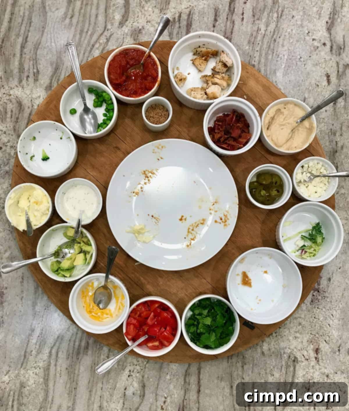 Empty Build Your Own Baked Potato Board after the meal, showcasing minimal leftovers, by The BakerMama.