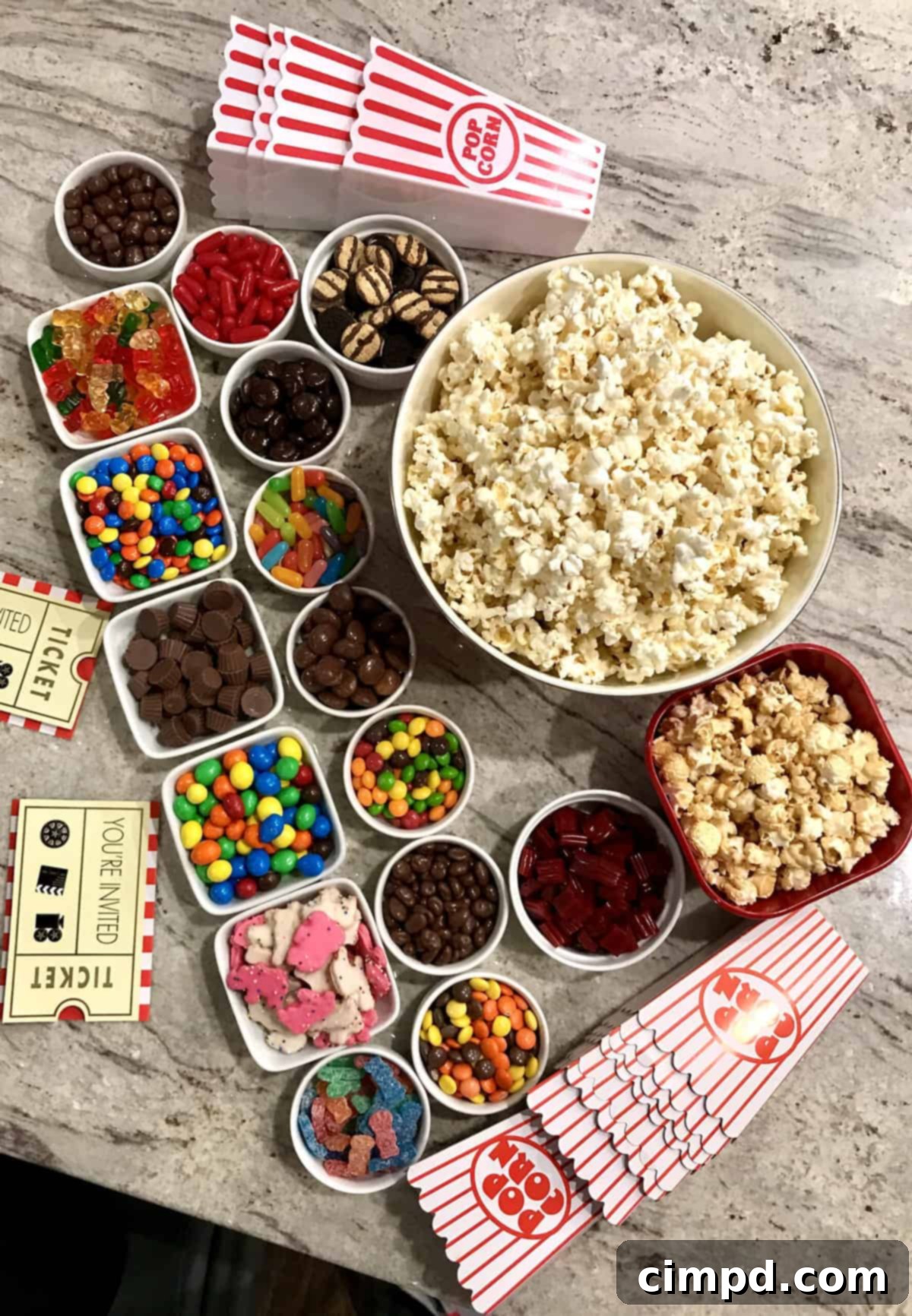 New Years Grazing Boards And Beyond 3 Fill-Your-Own Popcorn Box Spread by The BakerMama, offering a variety of toppings and mix-ins for a personalized snack.