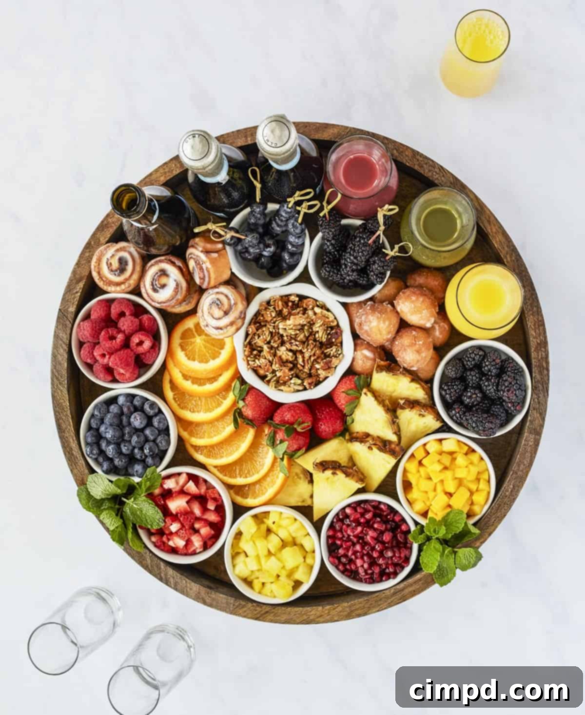 New Years Grazing Boards And Beyond 4 A vibrant Mimosa Board by The BakerMama's Beautiful Boards Cookbook, featuring champagne, juices, and fresh fruits.