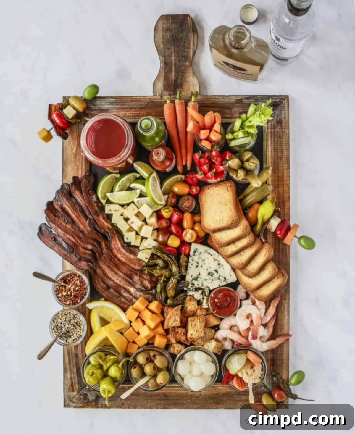 New Years Grazing Boards And Beyond 5 A robust Bloody Mary Board by The BakerMama's Beautiful Boards Cookbook, laden with savory garnishes.