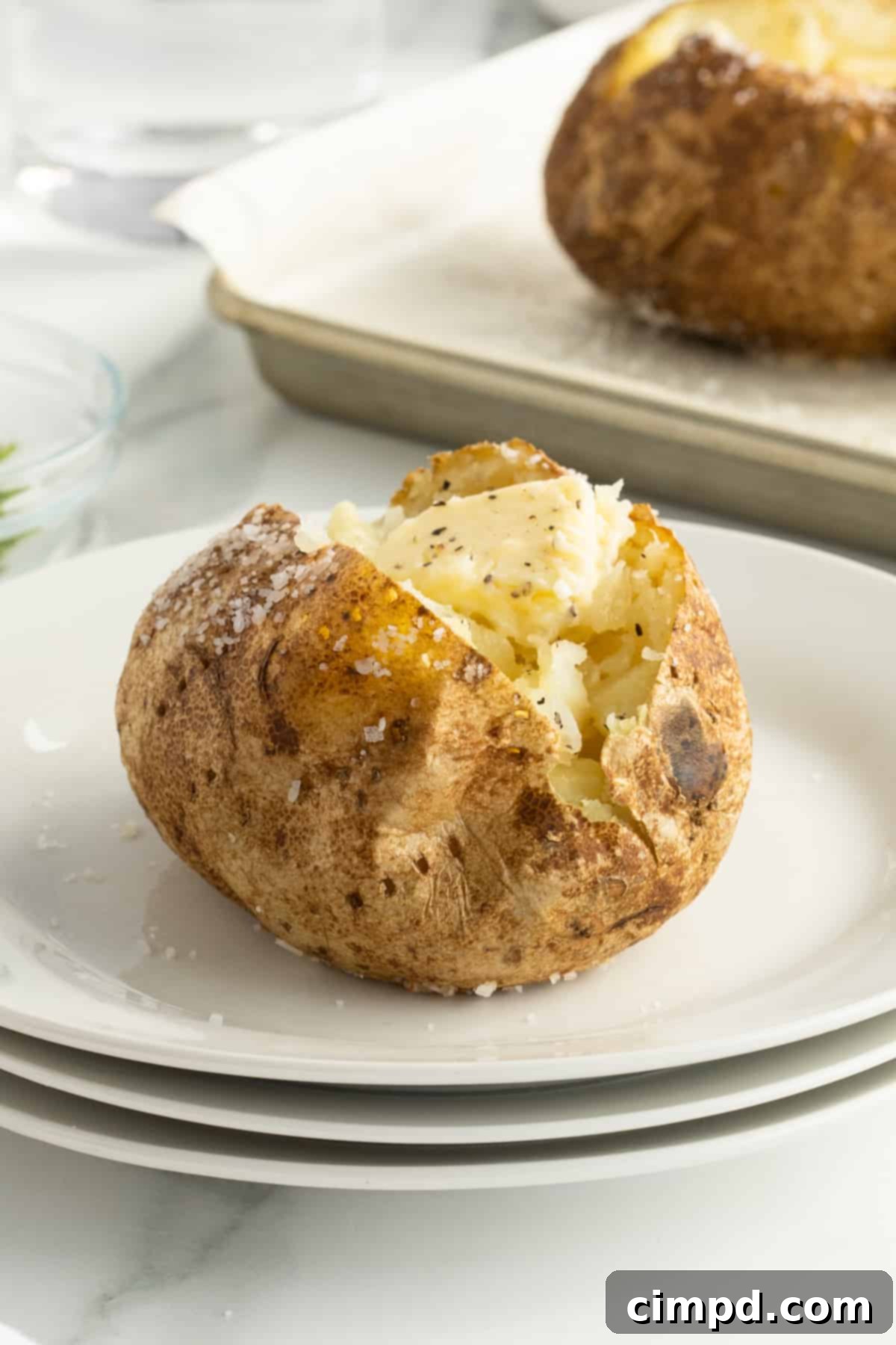 A selection of baked potatoes with various toppings on a serving board, by The BakerMama.