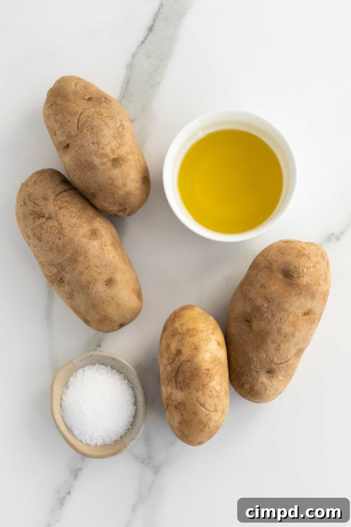 Ingredients for baking potatoes laid out on a kitchen counter, by The BakerMama.